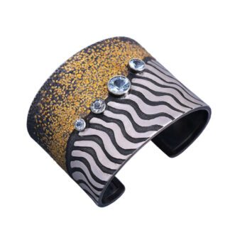 A cuff bracelet with gold and black stripes.