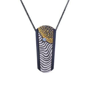 A necklace with a black and white pattern on it