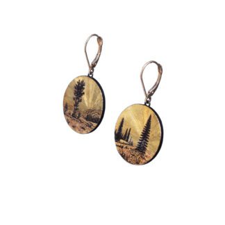 A pair of earrings with trees and mountains on them.