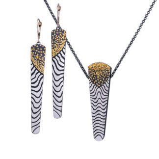 A pair of earrings and necklace with gold leaf design.