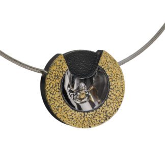A necklace with a yellow and black circle on it.