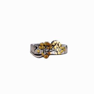A silver ring with gold flowers on it.