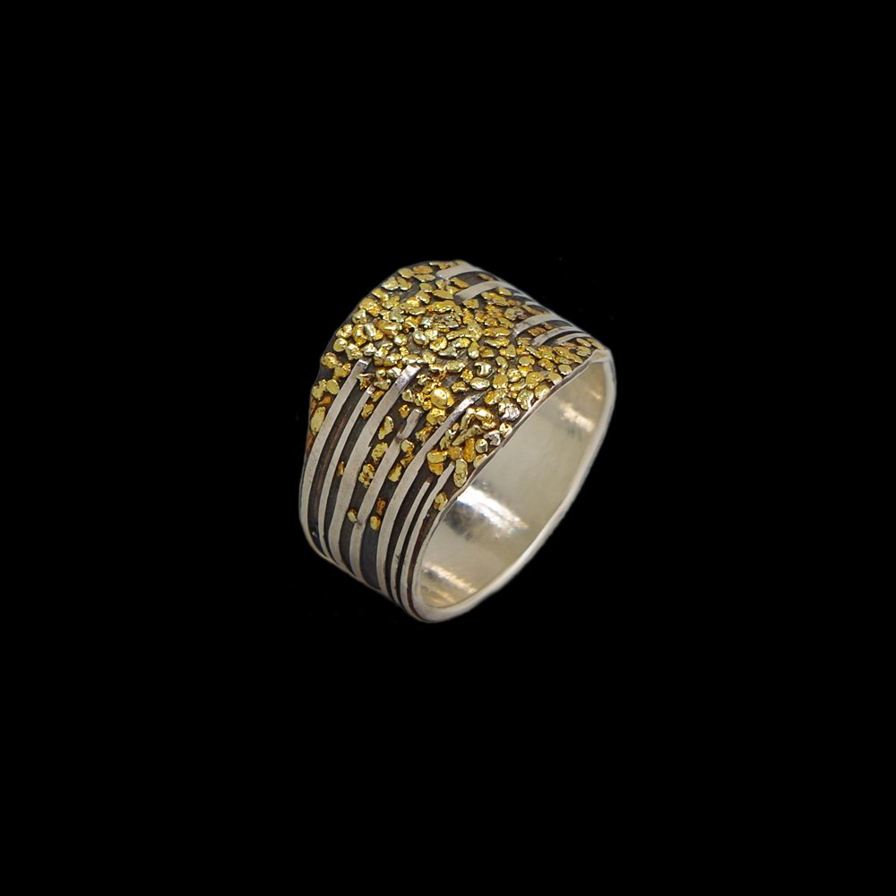 A silver ring with yellow stones on it.