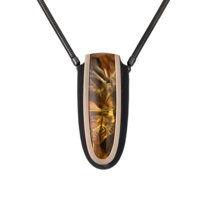 A necklace with a brown and black design on it.