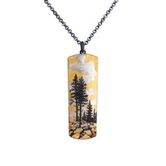 A necklace with trees and clouds on it.