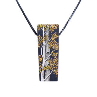 A rectangular pendant with gold leaves on it.