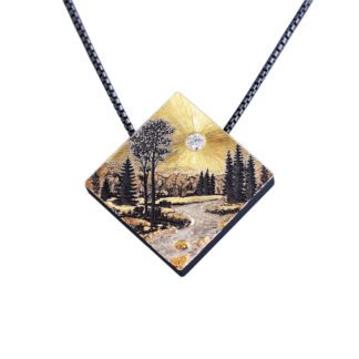 A painting of trees and water on a diamond shaped pendant.