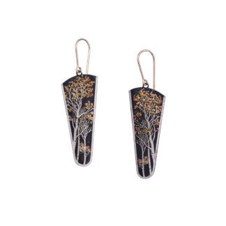 A pair of earrings with gold and black flowers.