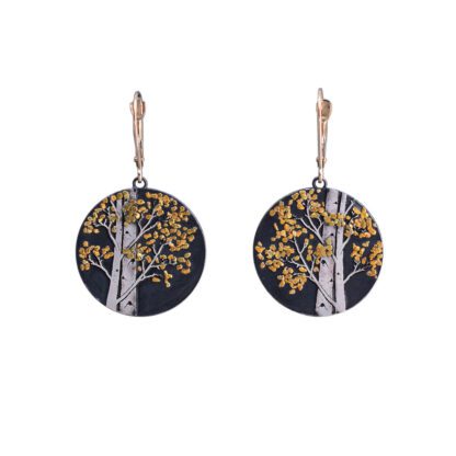 A pair of earrings with trees on them.