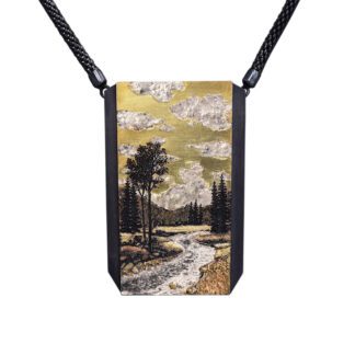 A painting of a river and trees on a necklace.