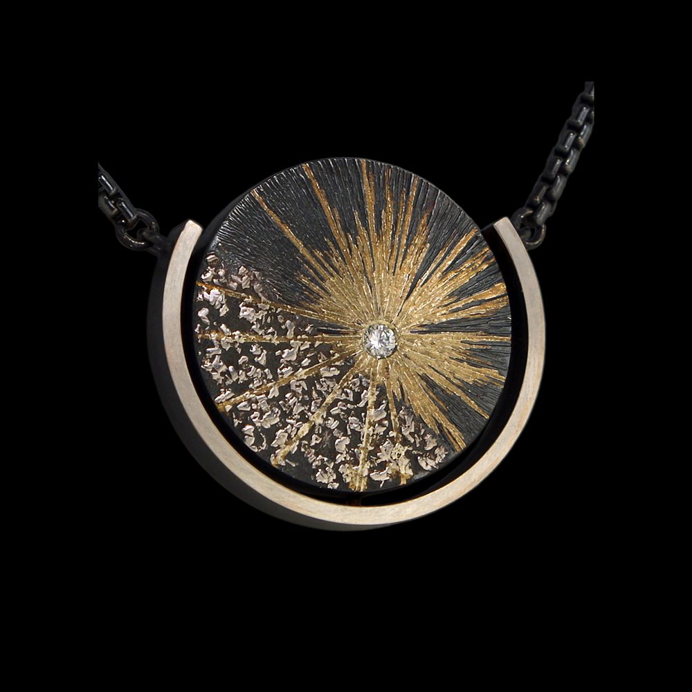 A necklace with a sun and moon design on it.