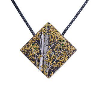 A square shaped necklace with a tree design.