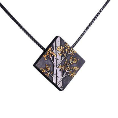 A black and gold necklace with a square shaped pendant.