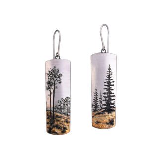 A pair of earrings with trees and mountains.