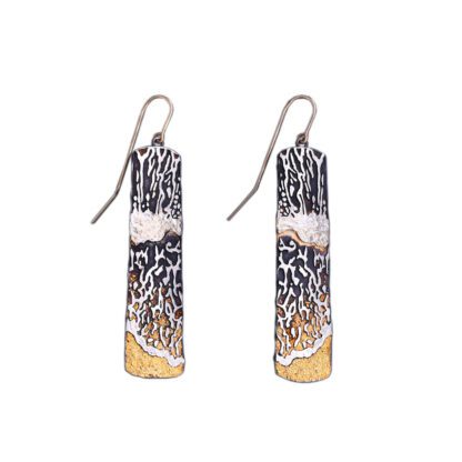 A pair of earrings with silver and gold foil.
