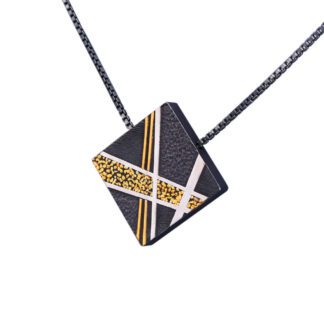 A black and white square necklace with gold accents.
