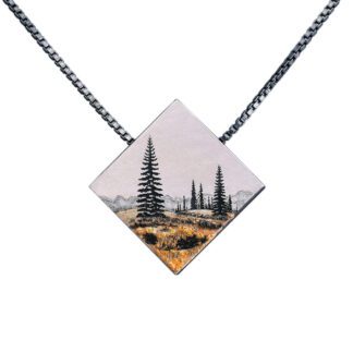 A necklace with a picture of trees on it.