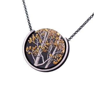 A necklace with a tree in the middle of it