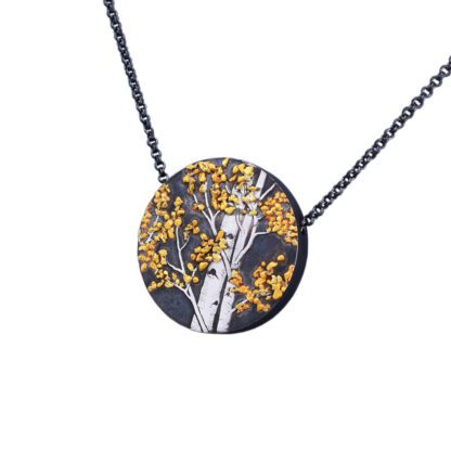A necklace with a black and yellow tree on it.