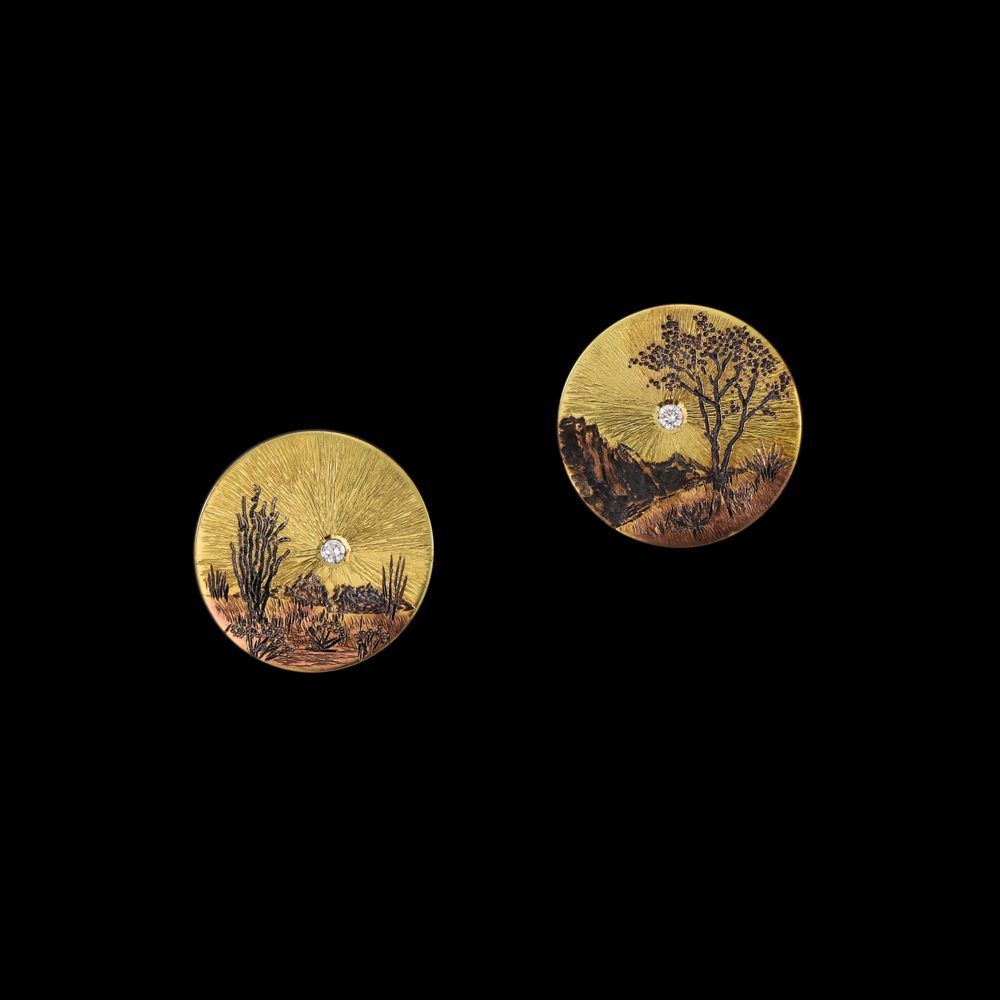A pair of round paintings on the side of a wall.