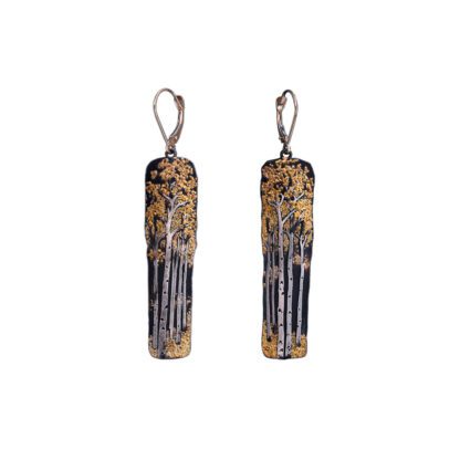 A pair of earrings with gold and black paint.