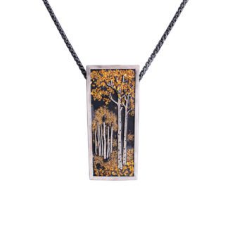 A rectangular pendant with trees in the background.
