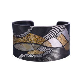 A black and gold cuff bracelet with a pattern of different shapes.