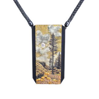 A painting of trees and mountains on a necklace.
