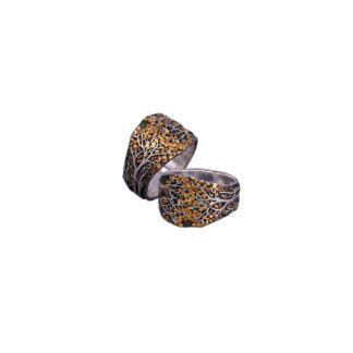 A pair of leopard print earrings sitting on top of each other.