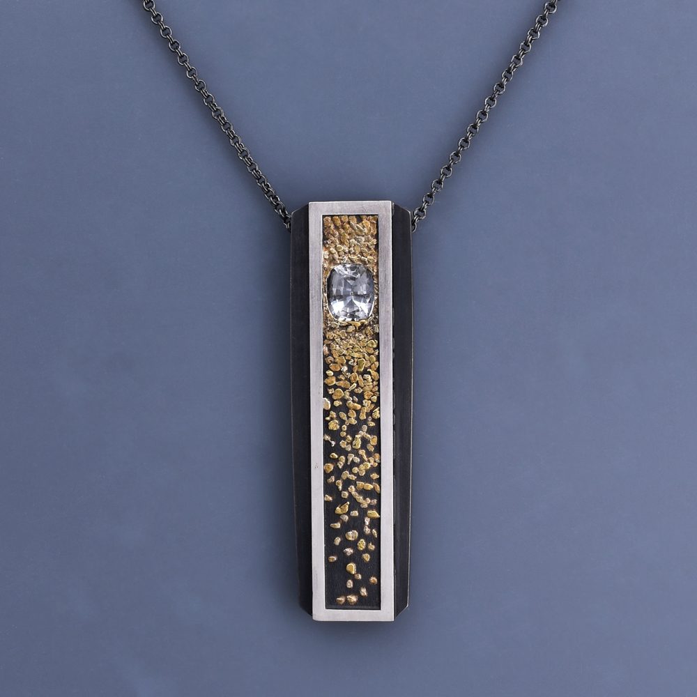 A necklace with a rectangular pendant and chain.