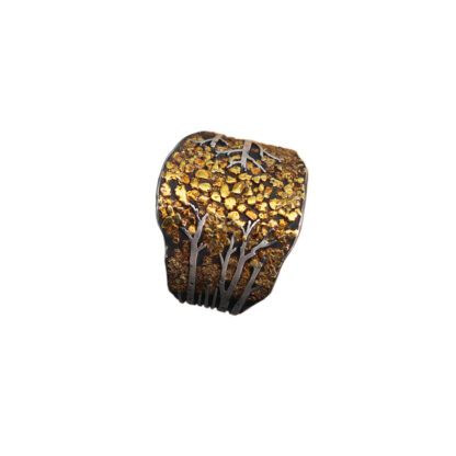 A rock with gold and silver paint on it.