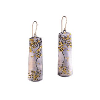A pair of earrings with yellow flowers on them.