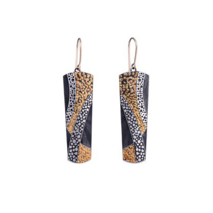 A pair of earrings with gold and silver leaf designs.