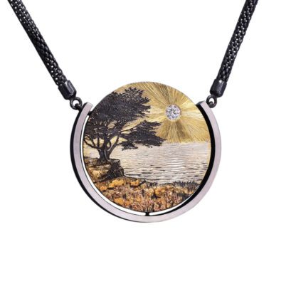 A necklace with a painting of trees and water