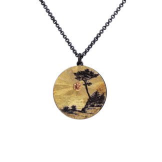 A necklace with a picture of trees and flowers.
