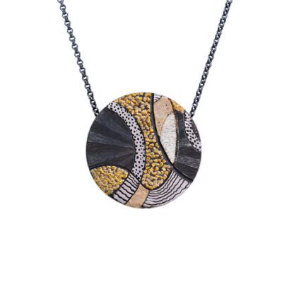 A necklace with a round shaped pendant on it.