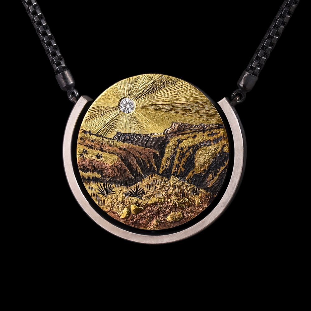 A necklace with a picture of a mountain
