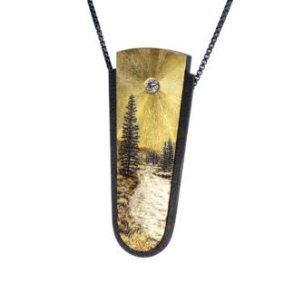 A necklace with a painting of trees and water.