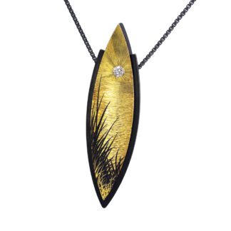A gold leaf necklace with a diamond on it.