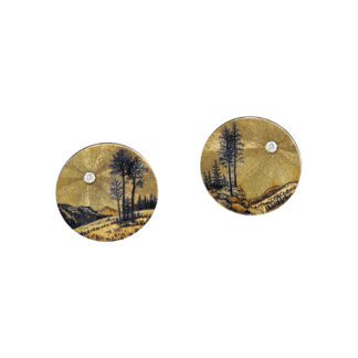 A pair of earrings with an image of a tree.