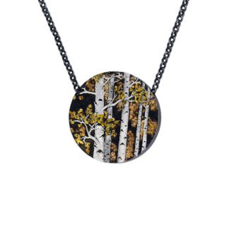 A necklace with a round pendant of trees