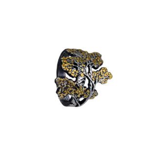 A black and gold leaf shaped pin.