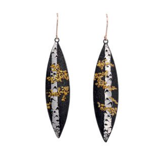 A pair of earrings with gold leaf and black paint.