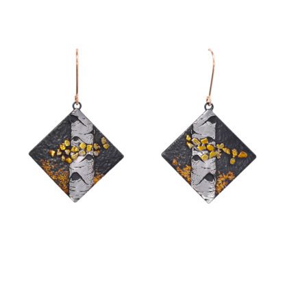 A pair of earrings with gold and silver foil.