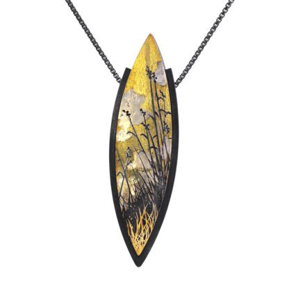 A yellow and black leaf shaped necklace with a chain.