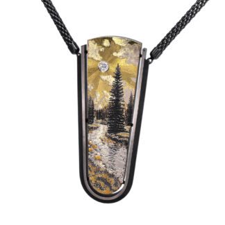 A necklace with a painting of trees and water.