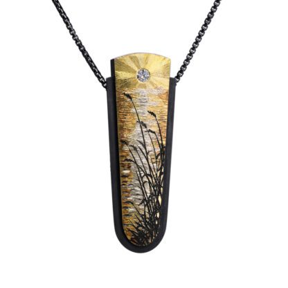 A necklace with a black and gold metal leaf design.