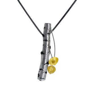 A silver necklace with two yellow beads hanging from it.