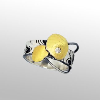 A silver ring with two yellow flowers and one diamond.