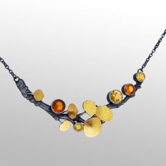 A necklace with yellow and orange stones on it.